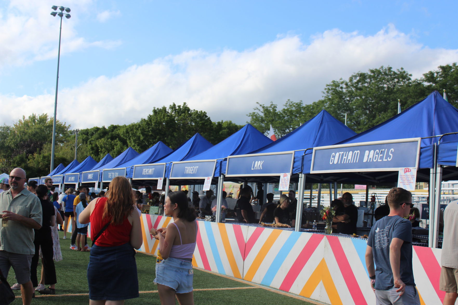 A shot of the two dozen food vendor booths serving desserts and dinner dishes during Madison's sixth annual Yum Yum Fest.JPG